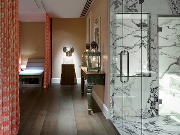 The corridor in the Soholistic Spa at Ham Yard Hotel with the steam room off to the right and the relaxation area at the end of the corridor on the left.