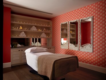 A treatment room at Soholistic Spa with a treatment bed.