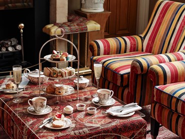 Champagne afternoon tea displayed on a table in the drawing room at the Knightsbridge Hotel.  